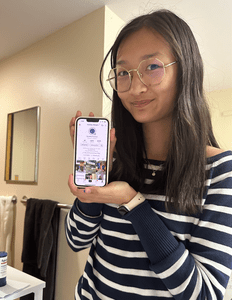 Student holding a phone logged in to Carleton TikTok